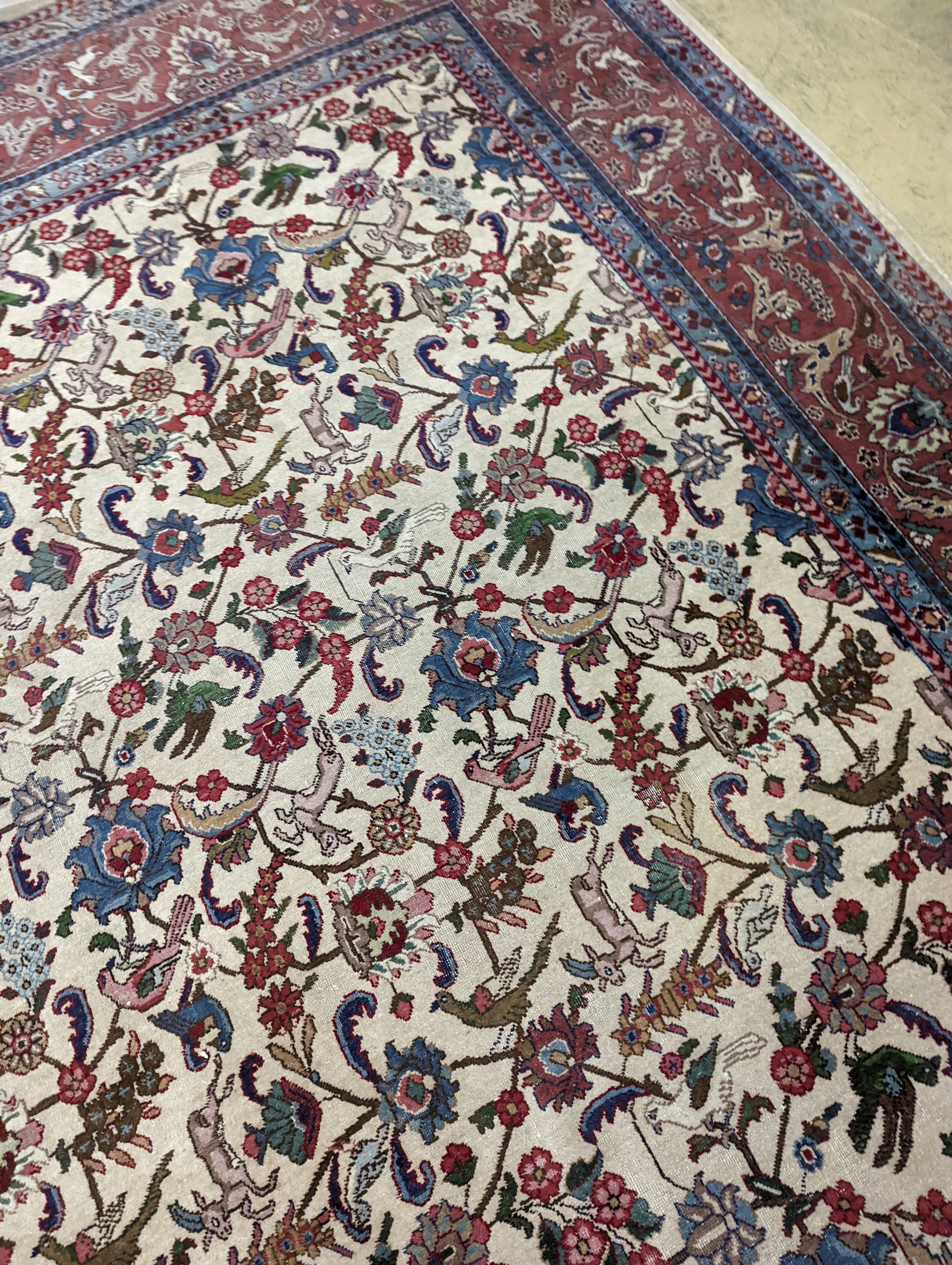 An Ispahan ivory ground carpet woven with flowers and animals, 386 x 276cm